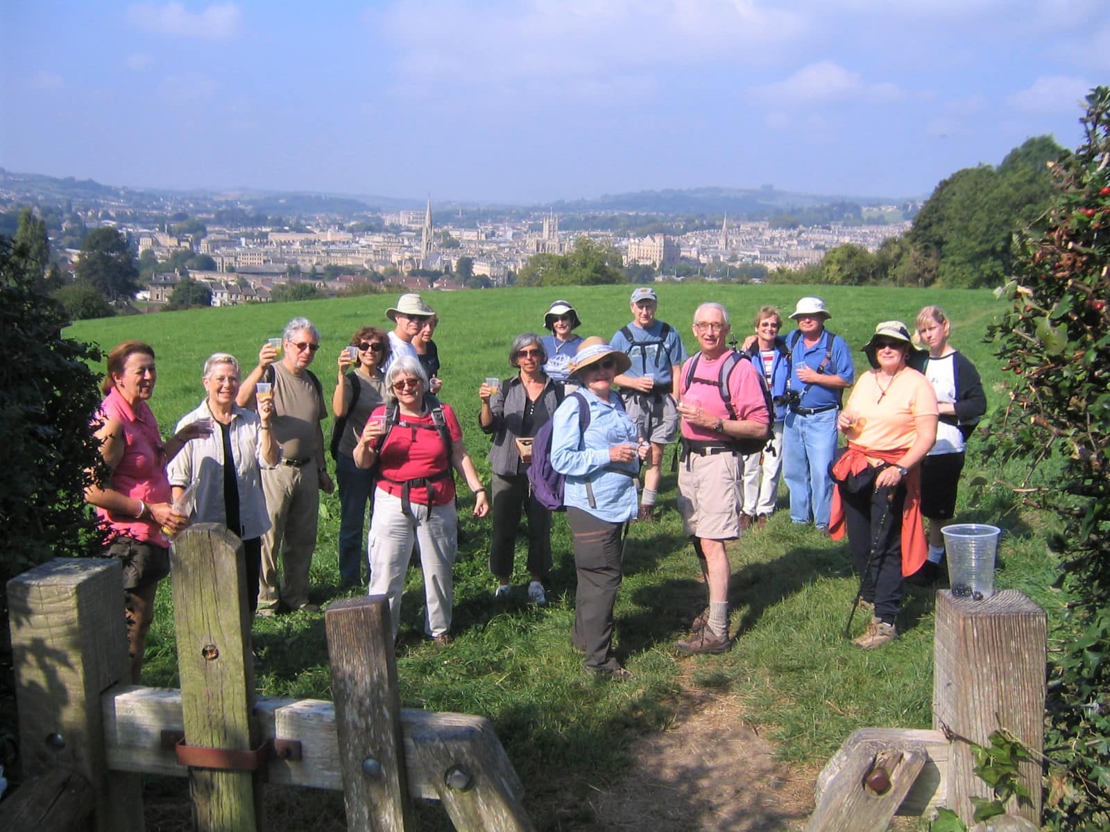 Clients celebrating the end of the Cotswolds Way, Bath in background