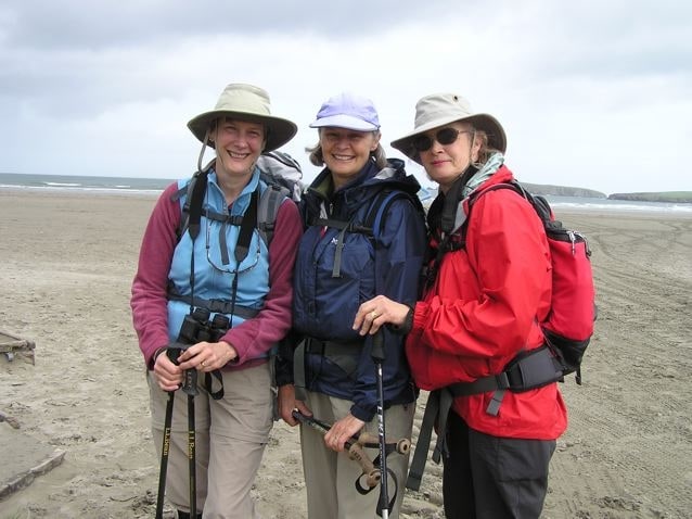 Three hikers on the beach