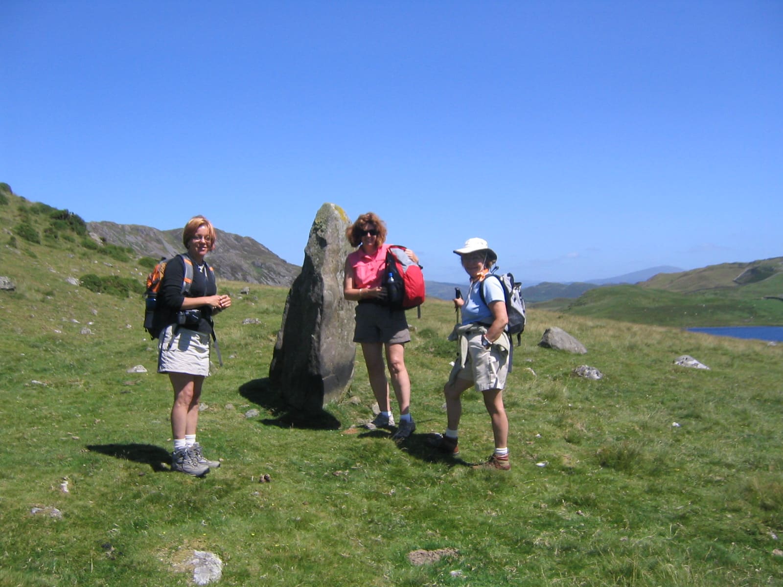 Image of walkers and standing stone in Wales, July