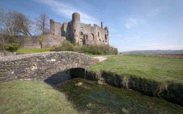Image of Laugharne Castle, with small bridge over the Taf Estuary