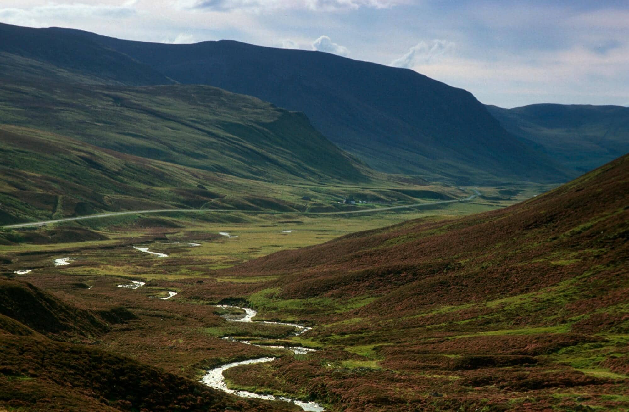 Heather covered moorland of Glenshee, with hills either side of the valley of Perth & Kenross