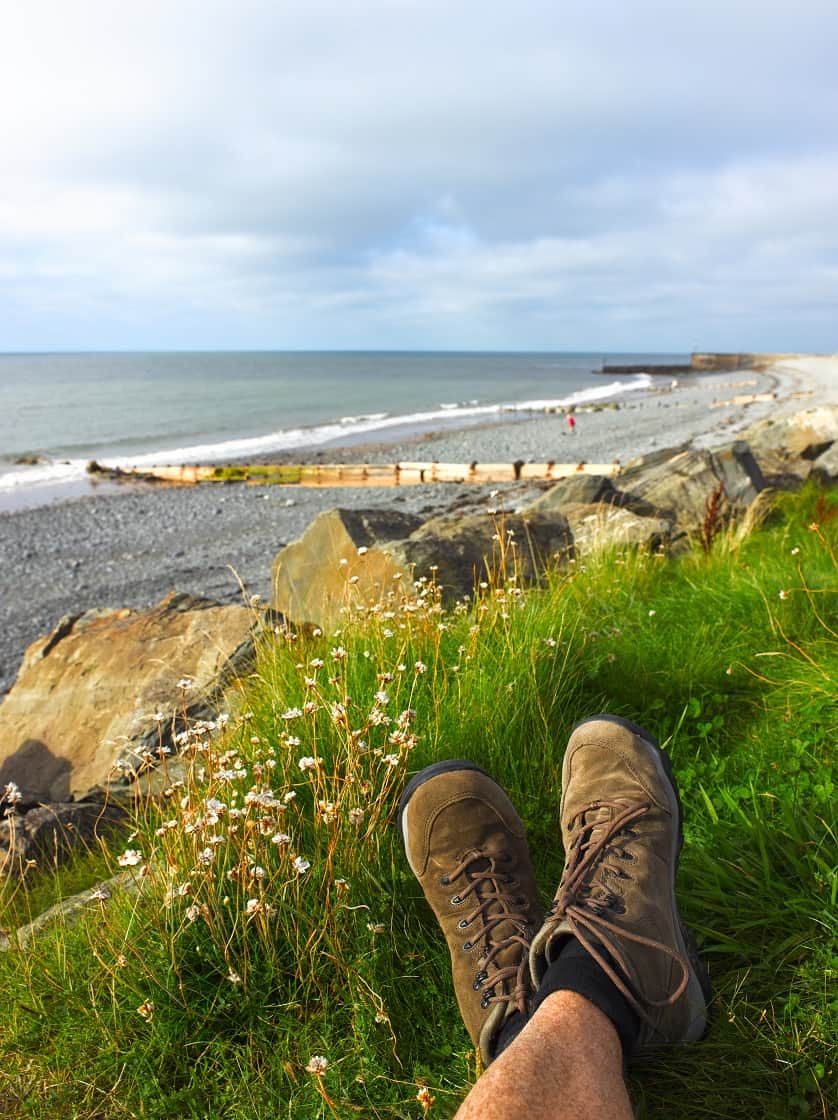 Walker along shores of Ceredigion Coast Path